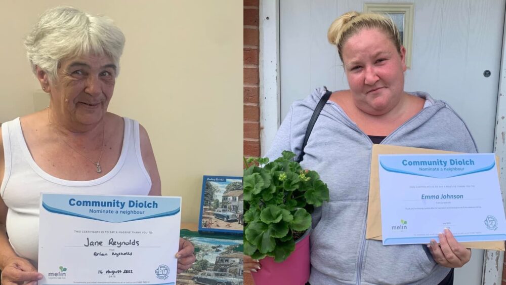 Two ladies holding certificates
