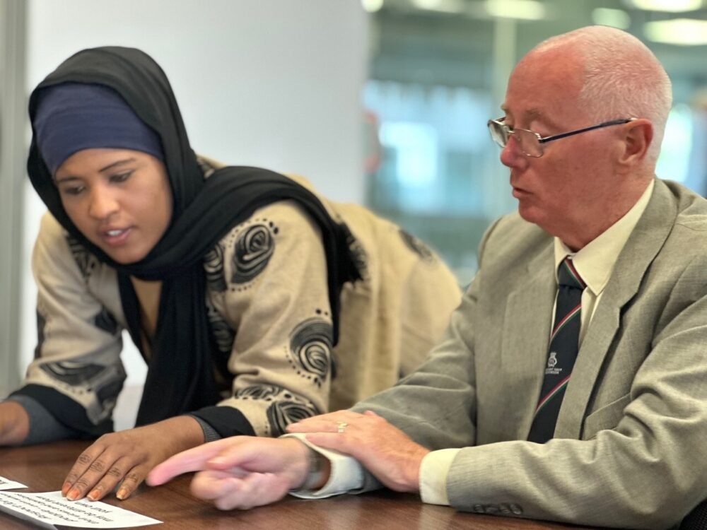 a woman and man both residents discussing what they want the new company to look like