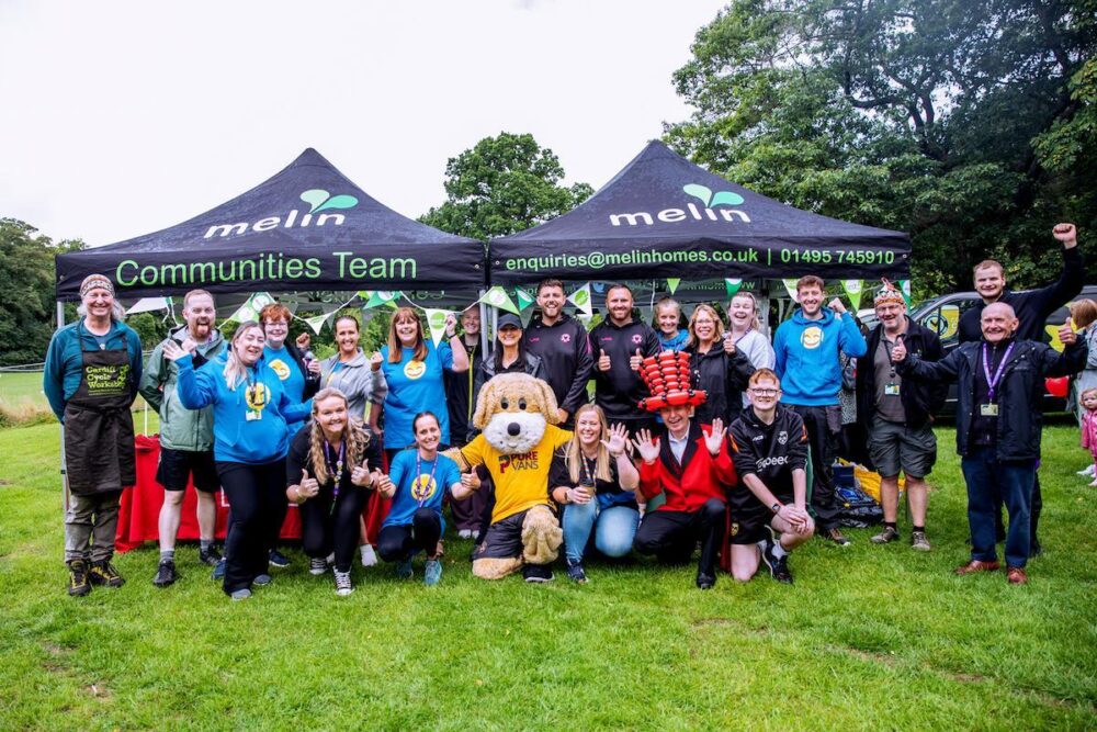 A picture of our Melin Team with partner organisations at our Zest in the Park event