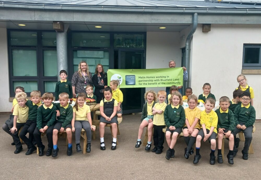 School children sat on new picnic benches