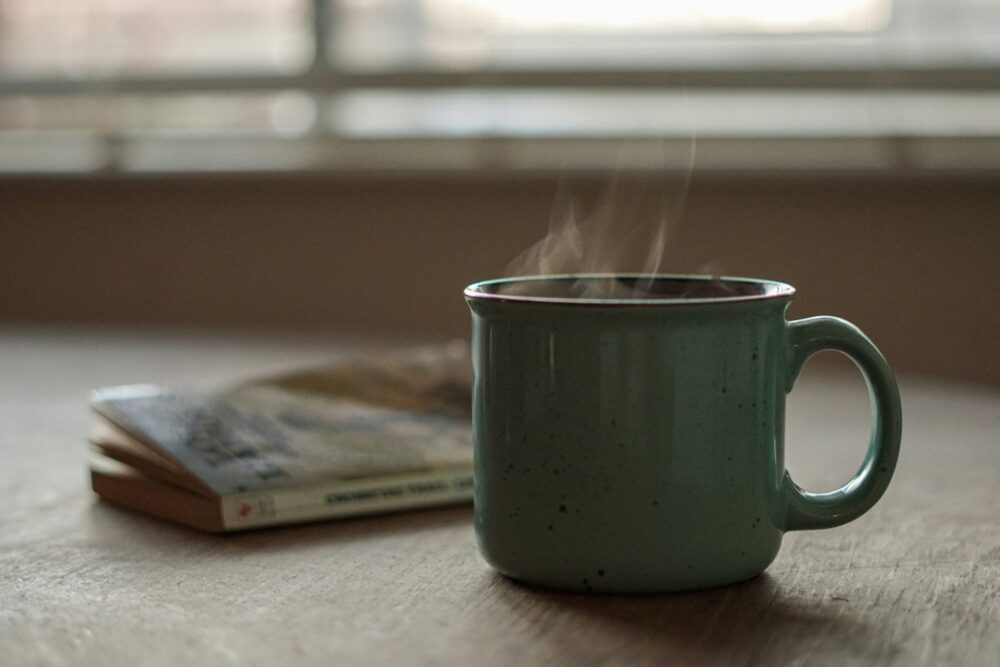 A person holding a warm cup of tea