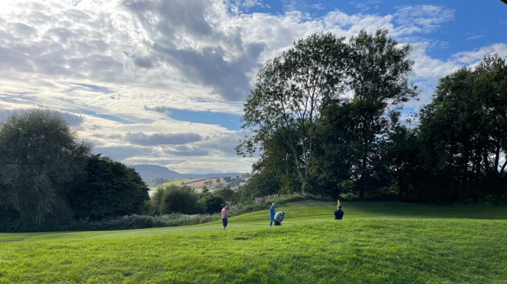 A landscape photo of the 18th hole on a sunny day