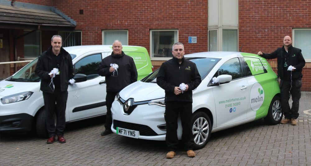 Four members of the Maintenance team holding white ribbons