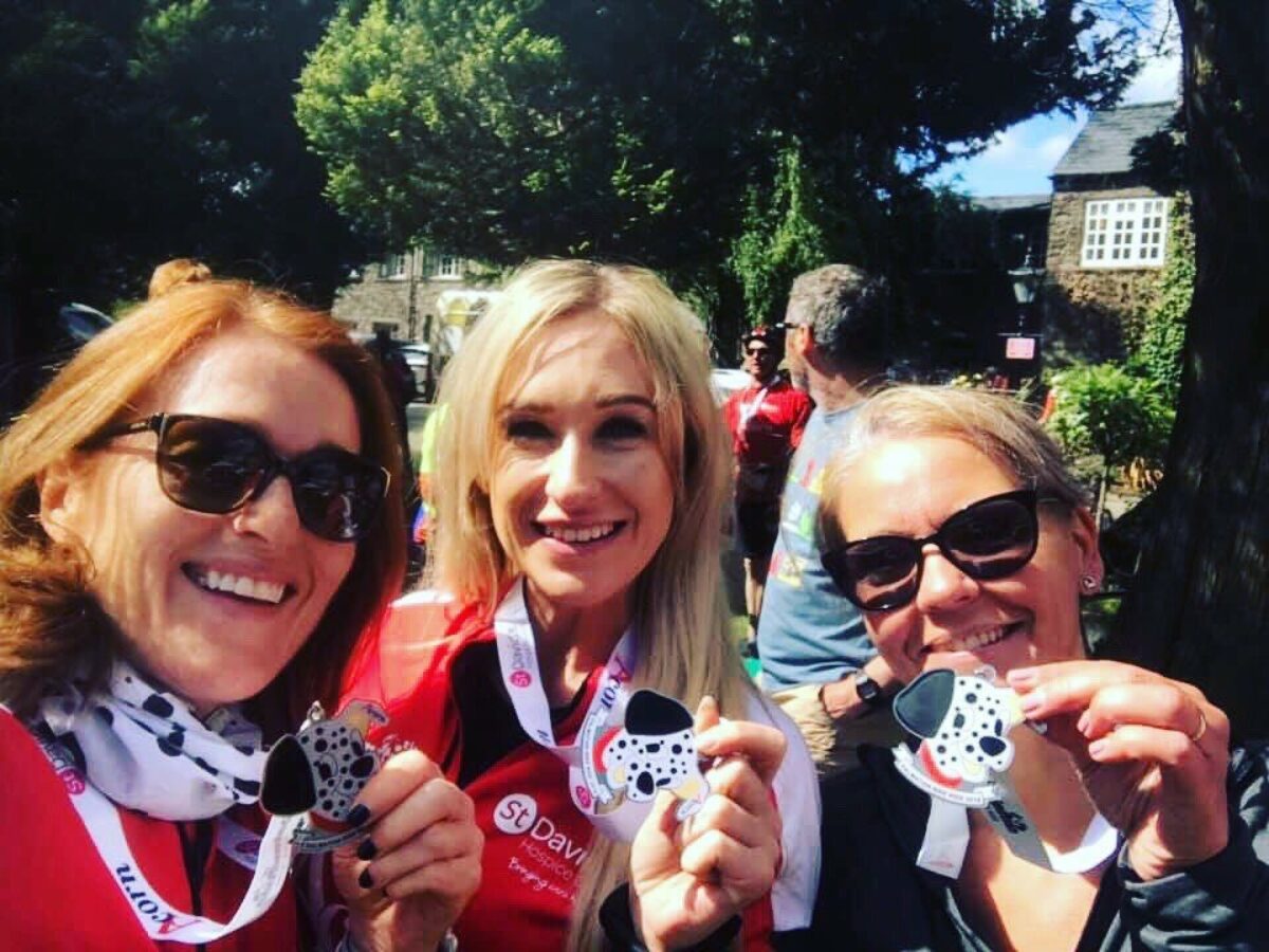 Three people holding medals