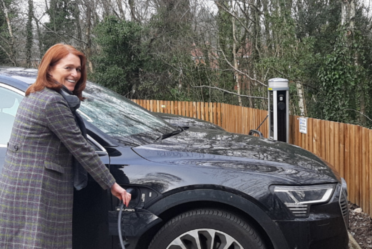 Paula Kennedy plugging in electric vehicle