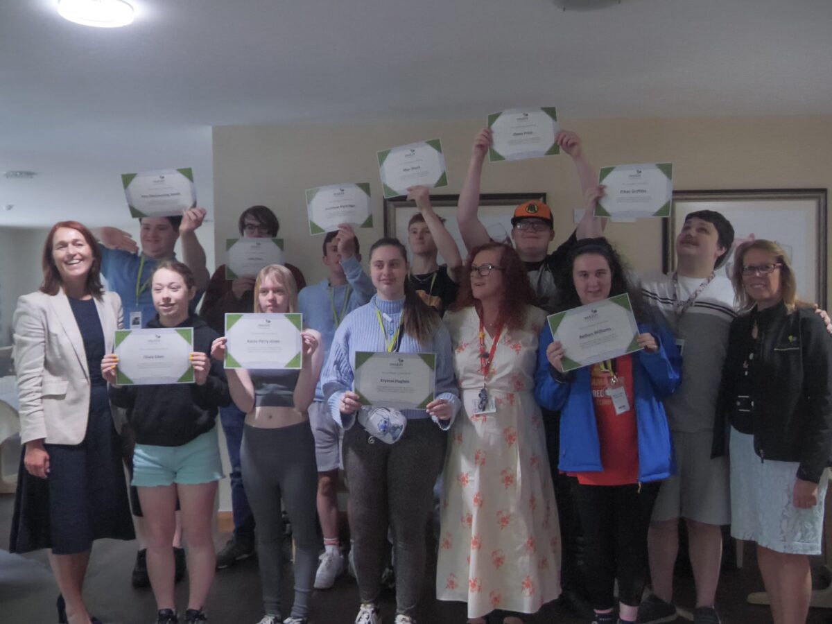 A group of college students holding certificates