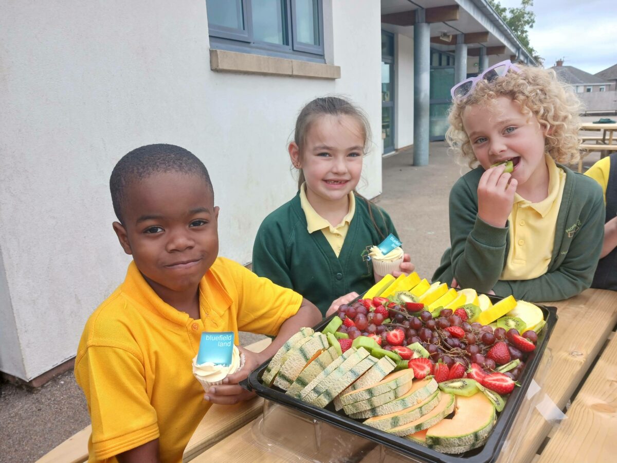 Children eating cakes and fruit